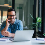 Portrait Of Young Smiling Cheerful Entrepreneur In Casual Office